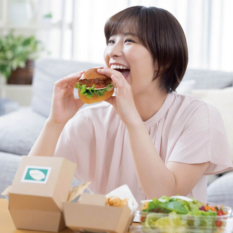 ハンバーガーを食べる女性