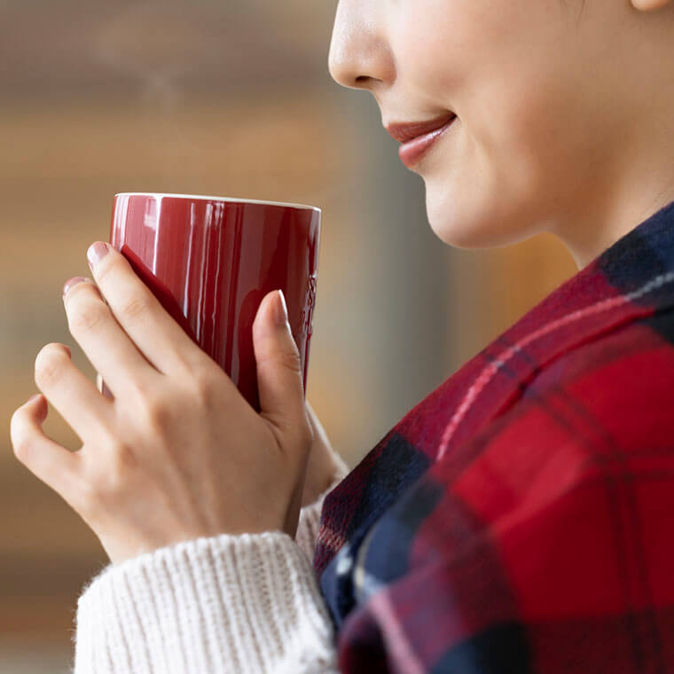 コーヒーの香りを楽しむ女性