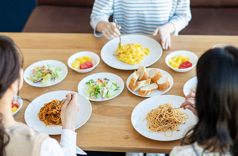 食卓を囲む女性　食事