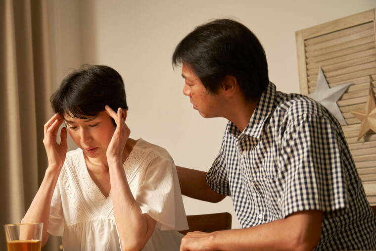 体調不良の女性といたわる男性