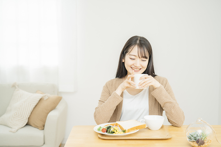 食事中に白湯を飲む女性