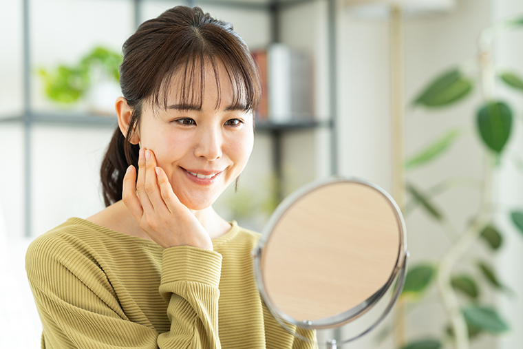 鏡を見て喜ぶ女性