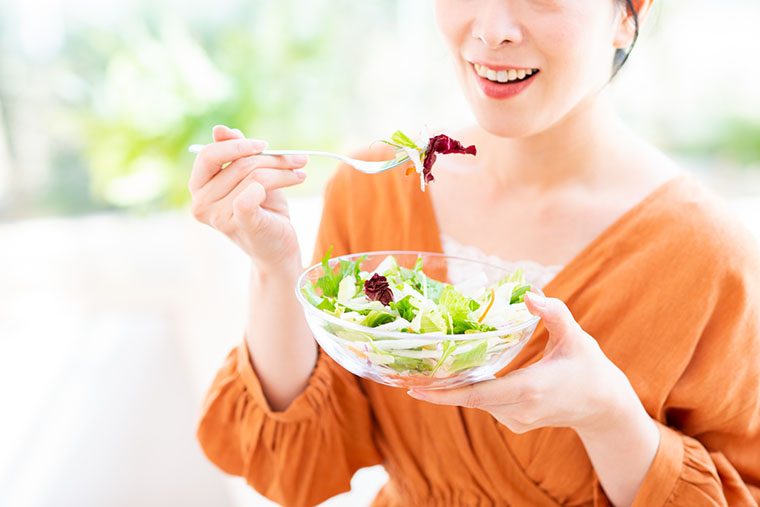 サラダを食べる女性