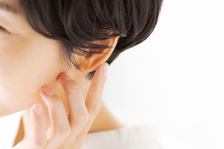 耳を触る女性